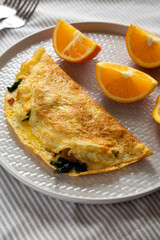 Homemade Bacon Spinach Omelette with Cheddar, side view.