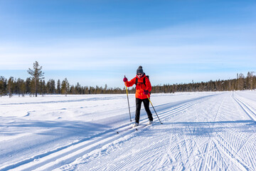 Woman cross country skiing in Lapland Finland