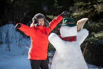 Snowman and woman in garden