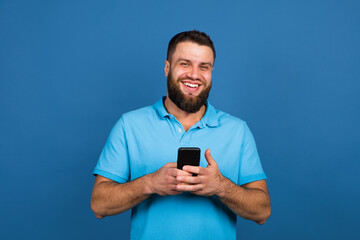 Caucasian man's portrait isolated on blue studio background with copyspace