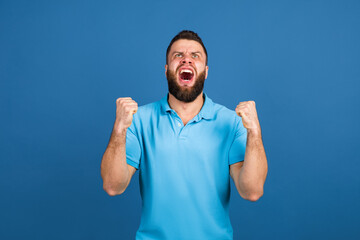 Fototapeta premium Caucasian man's portrait isolated on blue studio background with copyspace