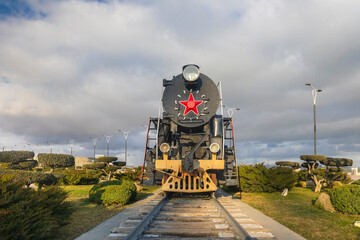 Old Soviet steam locomotive standing on the boulevard in Baku