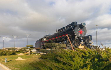 Old Soviet steam locomotive standing on the boulevard in Baku