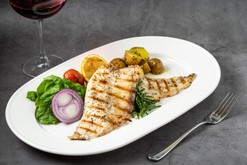 Grilled seabass fillet with garnish, seafood fish dish elegant presentation