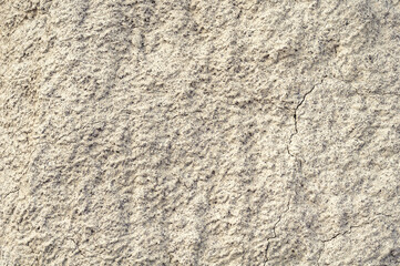 Background from blurred white clay rainy water, natural material, atmospheric impact, outdoors.