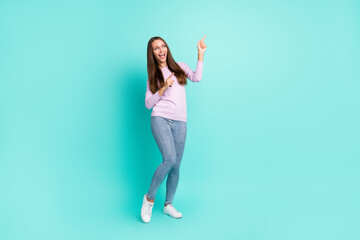 Full length body size view of lovely cheerful girl dancing showing copy space isolated over turquoise bright color background