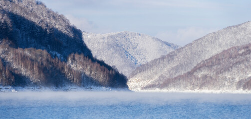 Winter landscape with mountains and lake. Winter magic landscape with scenic frozen mountain lake.