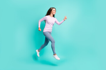 Fototapeta na wymiar Full length body size view of lovely cheerful girl jumping running marathon isolated over turquoise bright color background