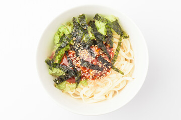Seasoning cut noodles on a white background