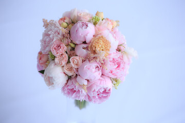Luxurious wedding bouquet of fresh pink peonies, astilba, English rose and carnations. The bride's bouquet.