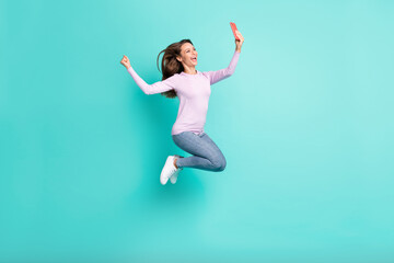 Full length body size view of lovely glad cheerful girl jumping making selfie having fun isolated over turquoise bright color background