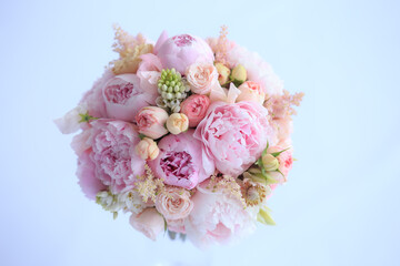 Luxurious wedding bouquet of fresh pink peonies, astilba, English rose and carnations. Bridal bouquet of peonies