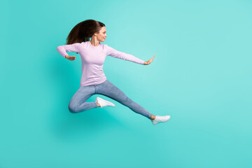 Fototapeta na wymiar Full length body size view of attractive girl jumping fighting dancing having fun isolated over turquoise bright color background