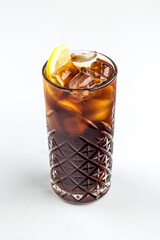 Isolated glass of long island ice tea cocktail with lemon slices