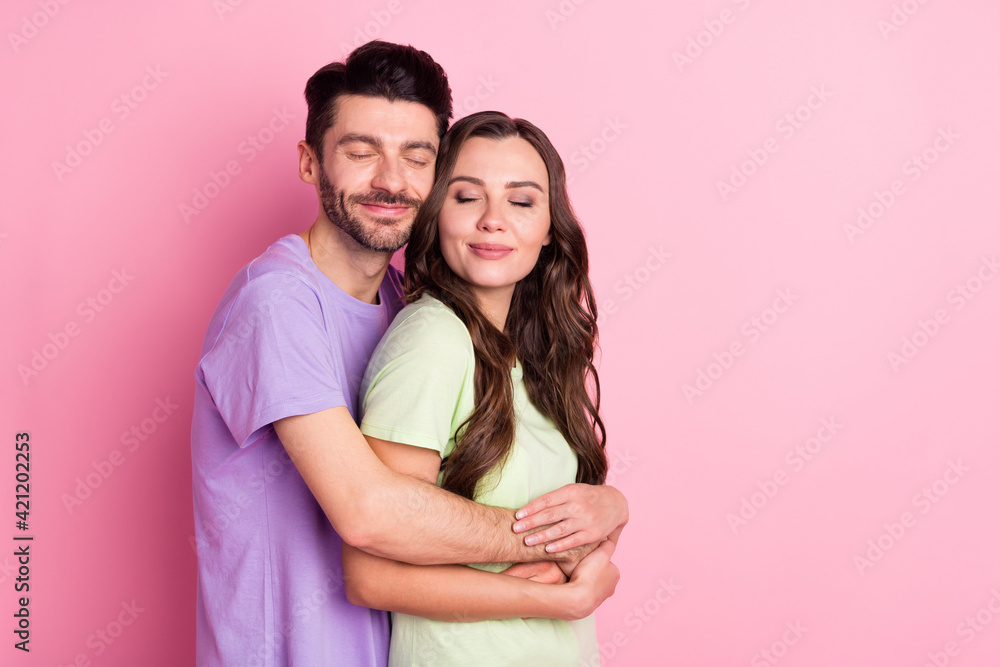 Wall mural portrait of attractive dreamy cheerful couple embracing amour sweetheart isolated over pink pastel c