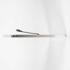 Square LED ceiling panel in metal housing on white background