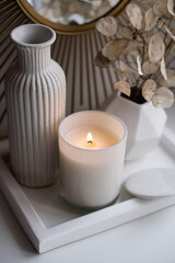 Fototapeta na wymiar Luxurious white tray decoration, home interior decor with burning candle
