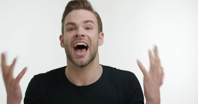 Portrait of Young Angry Man Screaming out showing Frustration. Having Furious Emotions feeling bad from Financial Problems. Touching his head Searching Solution of the Problem. Stress.