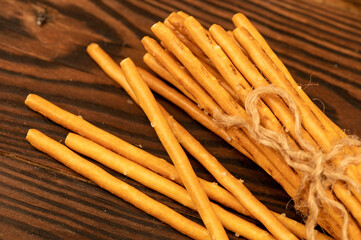 Salted breadsticks and salted pretzels scattered on the table.
