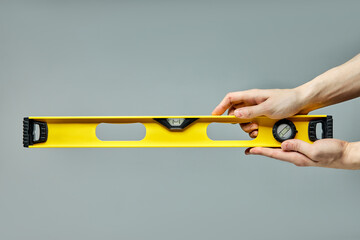 yellow spirit level, bubble level designed to indicate whether a surface is horizontal or vertical