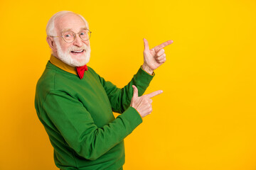 Photo of confident attractive mature man dressed pullover bow tie glasses pointing fingers empty...