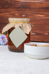 Jar of honey with honeycomb on a table. Mockup