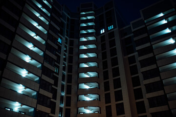 many identical windows in the building have lights on at night