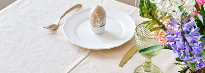 Easter table setting banner with natural Hyacinths flowers. Selective focus, home festive atmosphere