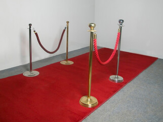 Red velvet carpet in studio with gold barrier