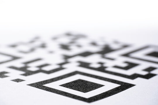 QR code printed on paper. Macro image. Focus on the bottom of the code, blurred gradient