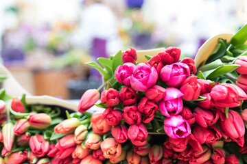 Huge bouquets of different shades of tulips on the counter of a large flower shop. Floral Flower Sales Center,