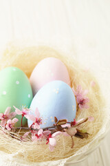 Obraz na płótnie Canvas White Easter egg in a nest basket on a white background.