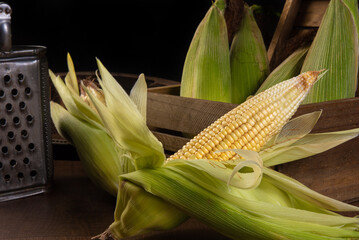 Festa Junina in Brazil, Green corn, grater and a sieve on a table, selective focus.