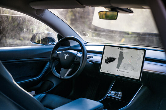 T&oslash;nsberg, Norway - march 18, 2021: black Tesla model 3 Long Range Dual motor is an electric car with Scandinavian forest in the background.