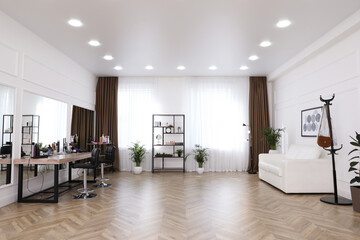 Fototapeta na wymiar Stylish beauty salon interior with hairdresser's workplace