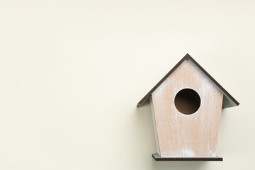 Obraz na płótnie Canvas Beautiful bird house on beige background, top view. Space for text