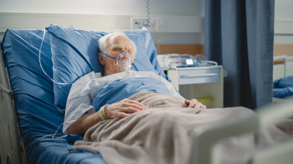 Hospital Ward: Portrait of Elderly Man Wearing Oxygen Mask Resting in Bed, Fully Recovering after...