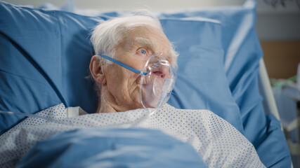 Hospital Ward: Portrait of Elderly Man Wearing Oxygen Mask Resting in Bed, Fully Recovering after...