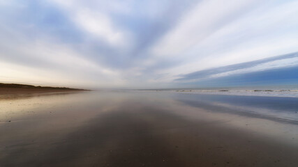 Fototapeta na wymiar Foggy morning in the Cotentin coast. Hauteville-sur-Mer beach