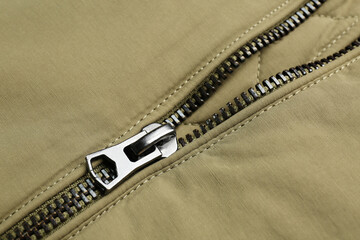 Grey jacket with zipper as background, closeup view