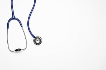 Stethoscope on white background, top view. Space for text