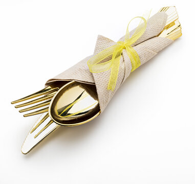 Golden Cutlery (knife, Fork And Spoon) With Napkin And Bow. Ready For Picnic. Isolated On White Background.