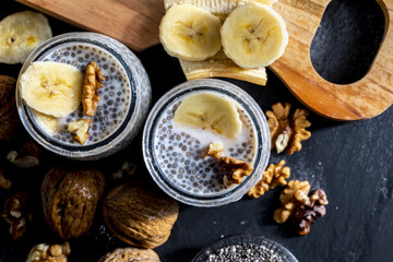 Appetizing, healthy and refreshing chia seed pudding with fresh blueberries and mint leaves. Vegetarian and vegan food with healthy superfoods. Homemade look. Top view with copy space.