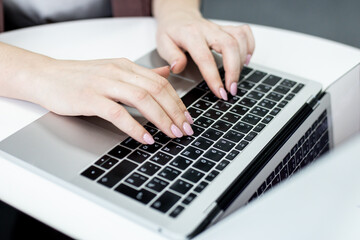 Female office worker typing on the keyboard,working at home office hand on keyboard close up. High quality photo