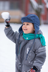 Winter portrait of little boy on a freezing day. Winter fun, kid winter playing -cute boy has a fun in snow