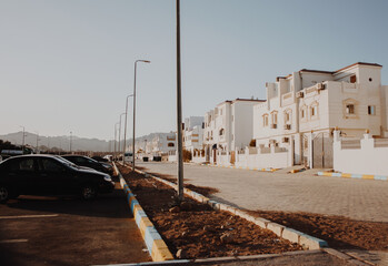 An everyday Egyptian street view with a cobbled transport and pedestrian street along the white...