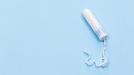 White tampon on the blue background, medical banner