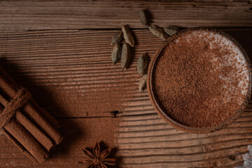 Glass of chai latte, hot latte foam garnish with ground cinnamon