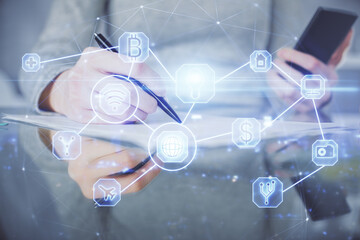 Double exposure of social network sketch hologram and woman holding and using a mobile device.