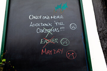 A comical sign written on a chalkboard asking when the lockdown will end. Covid 19 pandemic restrictions.